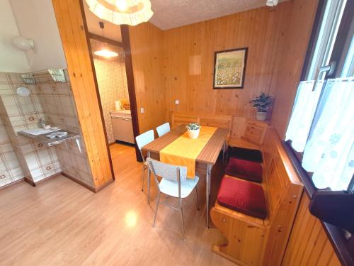a dining room with a wooden table and chairs at Apartma Ferjan in Žaga