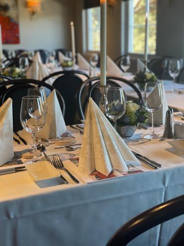 a table with wine glasses and napkins on it at Dølen Hotel in Evje
