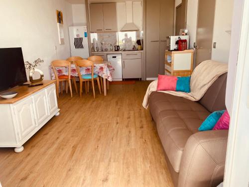 a living room with a couch and a kitchen at Sunny Home Costa Plana-Monaco -Cap D'Ail in Cap d'Ail