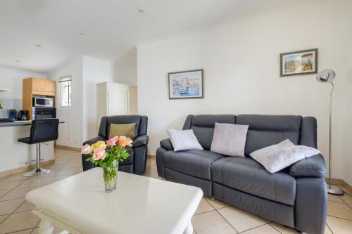 a living room with a couch and a table at Maison avec Piscine in Tourrettes