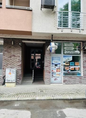 a door to a building with a sign on it at Goca Apartment in Skopje