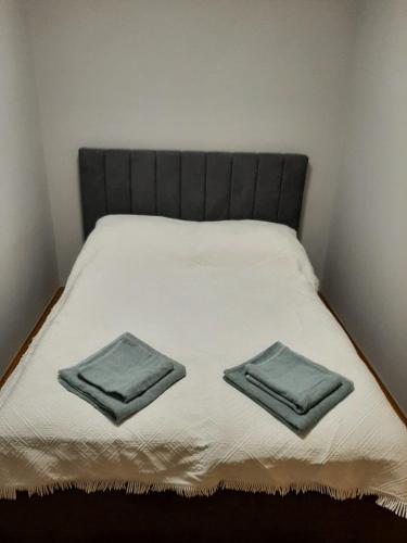 a bed with two towels on top of it at Apartament Sopotkowo "WYJĄTKOWY" in Sopot