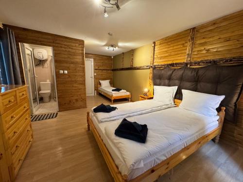 a bedroom with a large bed and a bathroom at Chalet Iskar Borovets in Borovets