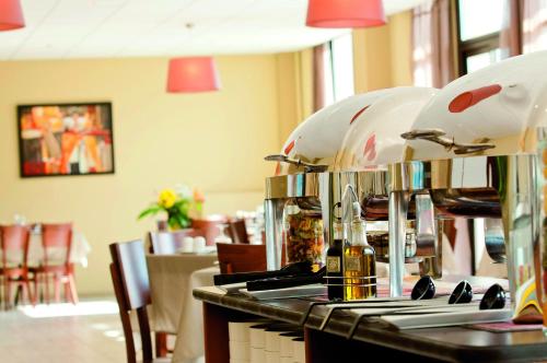 Un mostrador de restaurante con botellas de vino y cascos. en VTF Le Grand Hotel, en Montgenèvre