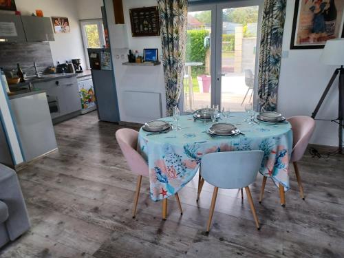 einen Tisch mit einem blauen Tischtuch drauf in einer Küche in der Unterkunft La maison entre deux plages,vue sur mer classée 4 étoiles in Criel-sur-Mer