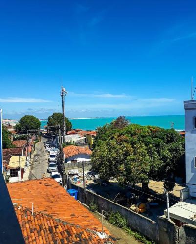 a view of a town with the ocean in the background at Casa Macao Pipa in Pipa