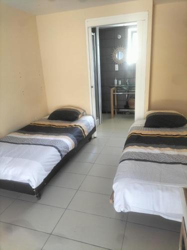 - 2 lits dans une chambre avec couloir dans l'établissement Ma bohème, à Pouldreuzic