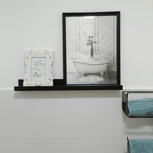 a bathroom with a bath tub and a mirror at Curota A in Ribeira