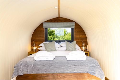 een slaapkamer met een bed met witte handdoeken bij The Piglets 3 in Yarmouth