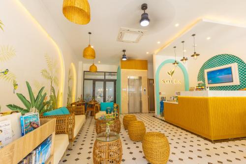 a restaurant with rattan chairs and a counter in a store at SOLÉA Hotel GrandWorld Phu Quoc in Phú Quốc