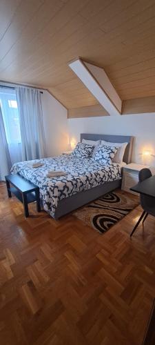 a bedroom with a large bed and a wooden floor at House Anita in Grabovac