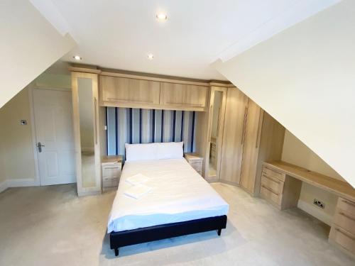 a bedroom with a large bed in a room at Emerson Park Mansion in Harold Wood
