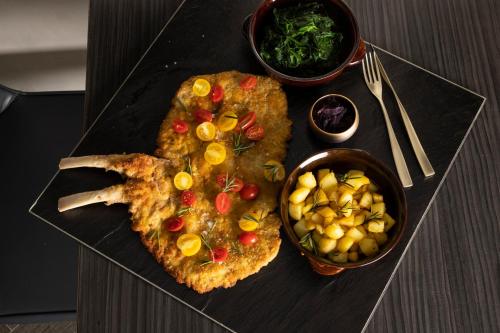 a plate of food with meat and vegetables on a table at Hilton Milan in Milan