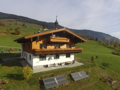 a large wooden house in a field of grass at Exquisite Apartment in Mittersill near Ski Area in Mittersill