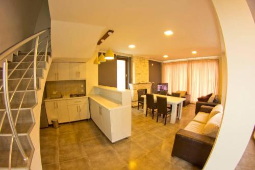 cocina y sala de estar con escalera y sala de estar en Aval-Bakuriani, en Bakuriani