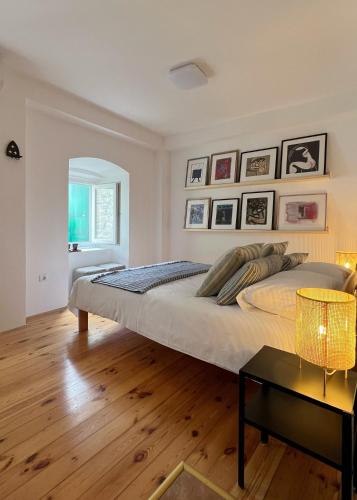 a large bedroom with a large bed and a table at Medieval Beachside Retreat in Risan