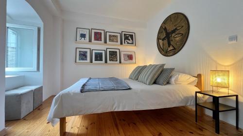 a bedroom with a bed with a large clock on the wall at Medieval Beachside Retreat in Risan