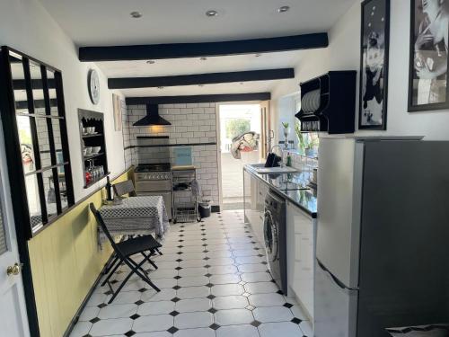 a kitchen with a black and white tiled floor at The Old Smithy in Ventnor
