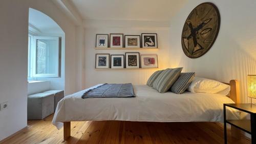 a bedroom with a bed with a large clock on the wall at Medieval Beachside Retreat in Risan