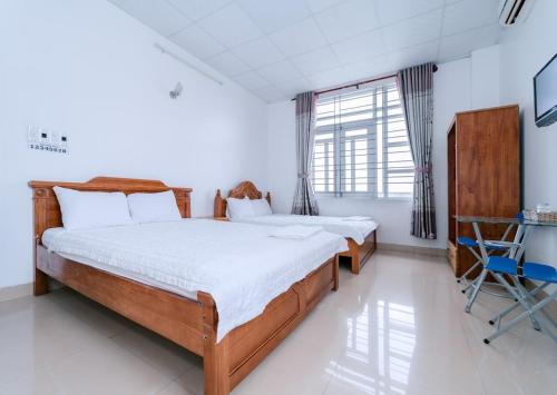 Ένα ή περισσότερα κρεβάτια σε δωμάτιο στο FGMN HOTEL Pleiku
