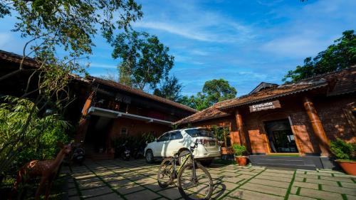 a car parked in front of a building at Mystery Maze Resort and Spa in Wayanad