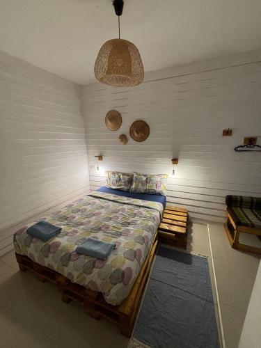 a bedroom with a bed in the corner of a room at La Locanda in Bangkok