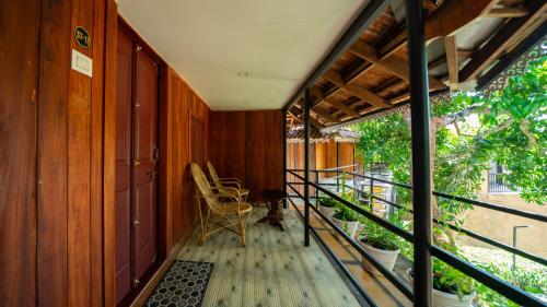 a balcony with a chair and some plants at Mystery Maze Resort and Spa in Wayanad
