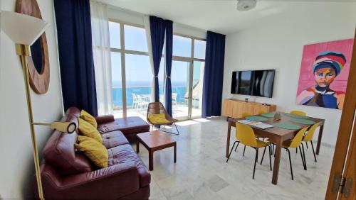 a living room with a couch and a table at 42nd floor - Penthouse VIP with private terrace and sea views in Benidorm