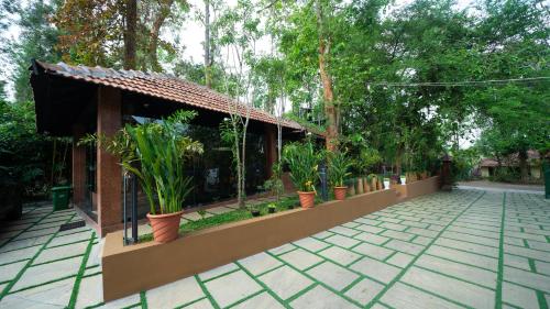 a courtyard with potted plants and a building at Mystery Maze Resort and Spa in Wayanad