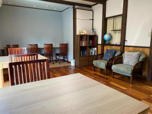 a living room with chairs and a table and a book shelf at Ryokan Seifuso - Vacation STAY 85475v in Matsumoto