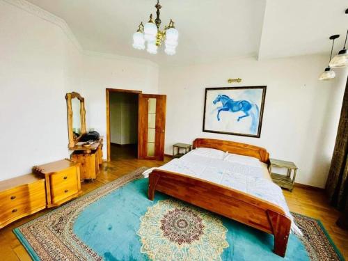 a bedroom with a large bed and a blue rug at Five seasons guest house in Ulaanbaatar