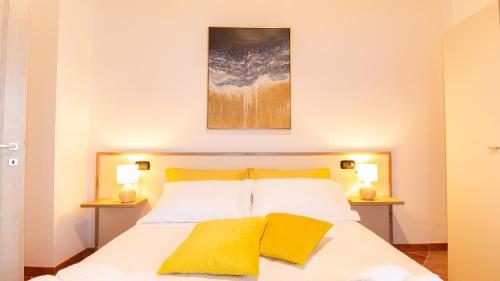 a bedroom with a large bed with yellow pillows at Sardinianworld - Domo Mea in Càbras