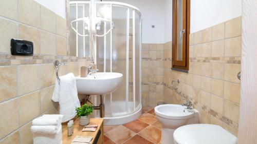 a bathroom with a sink toilet and a shower at Sardinianworld - Domo Mea in Càbras