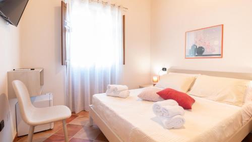 a bedroom with a bed with towels on it at Sardinianworld - Domo Mea in Càbras