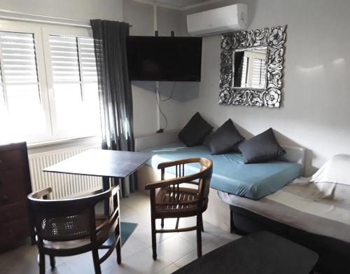 a living room with a couch and a table and chairs at Gardenia 1 in Stadtlauringen