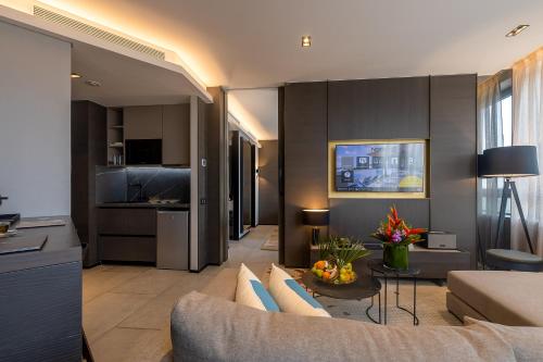a living room with a couch and a table at Noom Hotel Abidjan Plateau in Abidjan