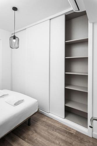 Ένα ή περισσότερα κρεβάτια σε δωμάτιο στο Apartamentos Isabella by Concept Flats