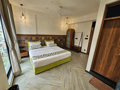 a bedroom with a large bed in a room at Nova Park in Rajkot