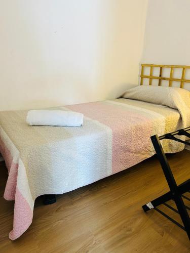 a bedroom with a bed with a towel on it at Apartamento Luna en Playa de Gandía in Gandía