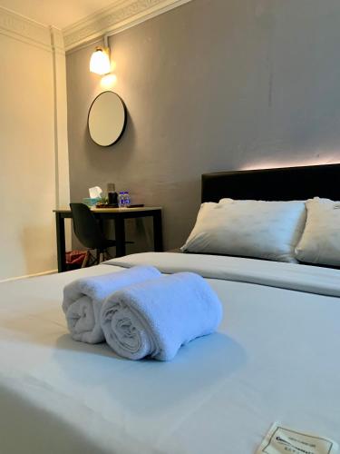 a hotel room with two beds with towels on the bed at Andiana Hotel & Lodge - Kota Bharu City Centre in Kota Bharu
