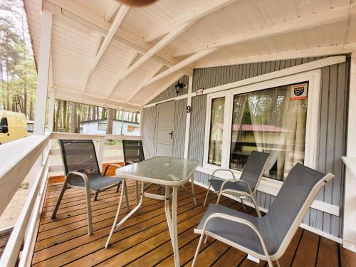 a screened porch with a table and chairs on it at Letnisko BAJKA in Iława