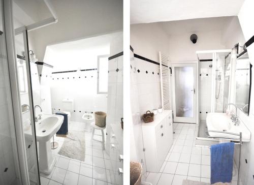 een witte badkamer met een wastafel en een toilet bij La casa del papavero in Lucca