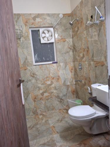 a bathroom with a toilet and a sink at 636 Kedia Kothhi in Jaipur