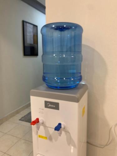 a blue water container sitting on top of a refrigerator at Andiana Hotel & Lodge - Kota Bharu City Centre in Kota Bharu