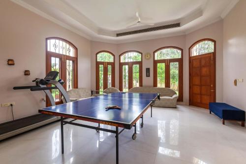 a living room with a ping pong table at Krishnalaya Mansion by VEO - Part of StayVista in Jaipur