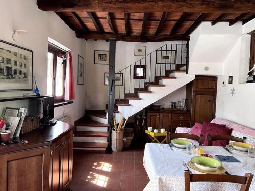 a living room with a spiral staircase and a table at Casa Silvia in Lucca