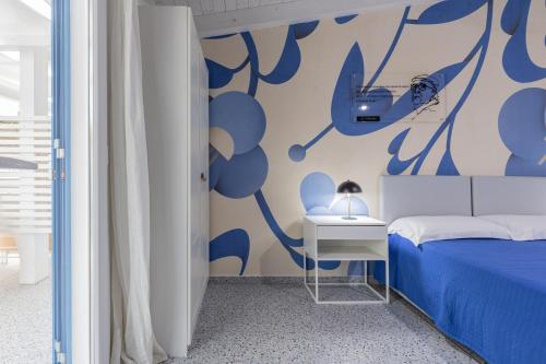 a bedroom with a bed and a table with a lamp at La Scala Suite in Realmonte