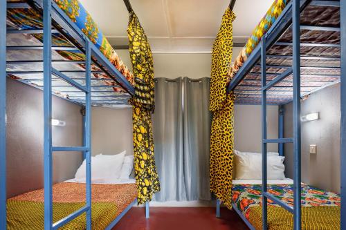 a bunk bed room with two bunk beds at Victoria Falls Backpackers Zambia in Livingstone