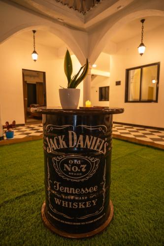 a barrel with a plant in the middle of a room at Sapphire Mansion in Alibag