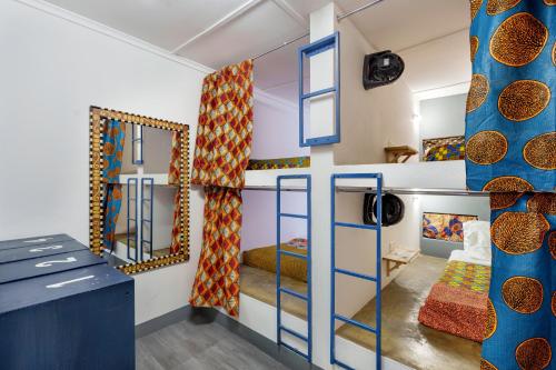 a room with two bunk beds and a kitchen at Victoria Falls Backpackers Zambia in Livingstone